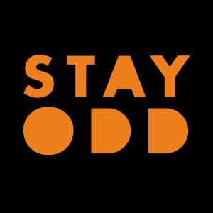 Stay Odd T-Shirt, Bold Text T-Shirt, Unique Statement Tee, Unisex Graphic T-Shirt, Cotton Stay Odd Shirt, Trendy Odd T-Shirt, Festival Style T-Shirt, Casual Bold Print Tee, Stay Odd Clothing, Quirky Graphic T-Shirt